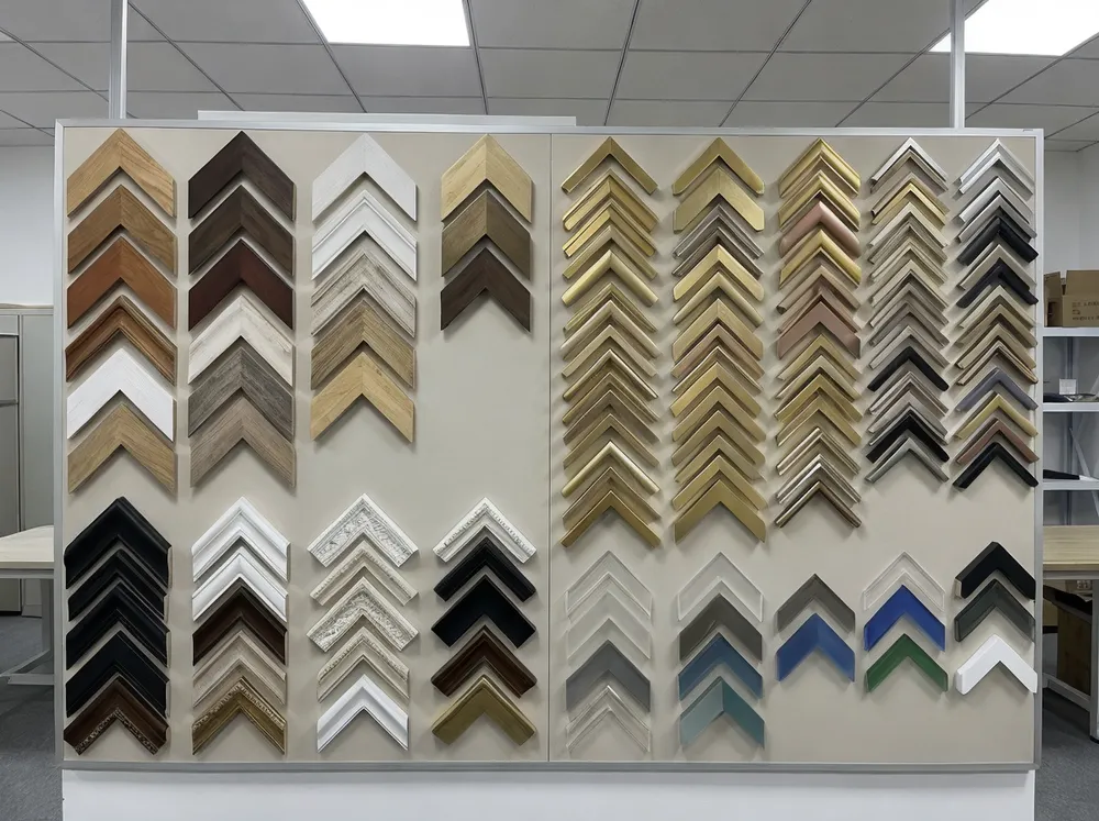 Sample display showing wood, metal, resin, and acrylic mirror frame materials with various finish options