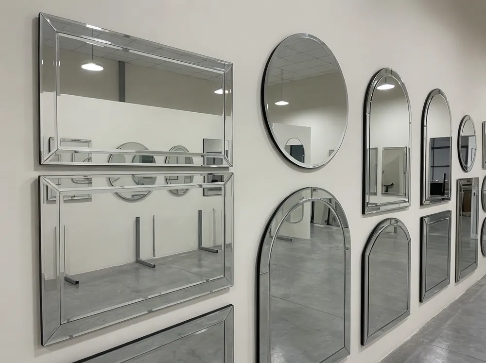 Frameless wall decor mirrors with beveled edges displayed in a showroom setting