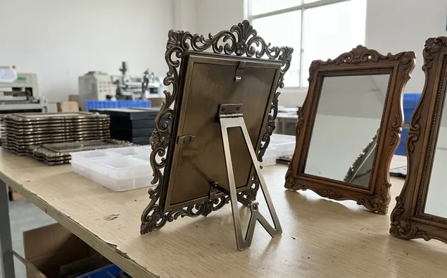 Small decorative standing mirrors with ornate frames and easel backs