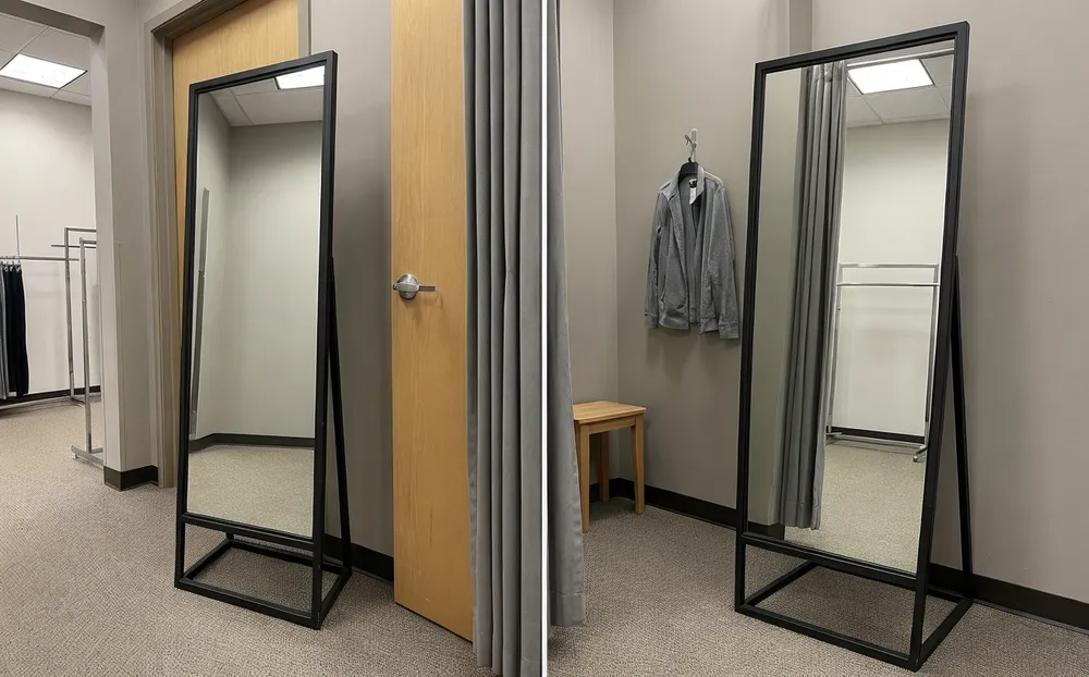 Powder-coated metal frame floor mirror in clothing retail fitting room environment