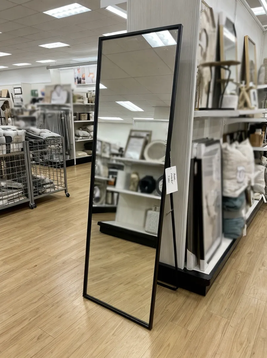 Full-length floor decor mirror with metal frame in retail display setting