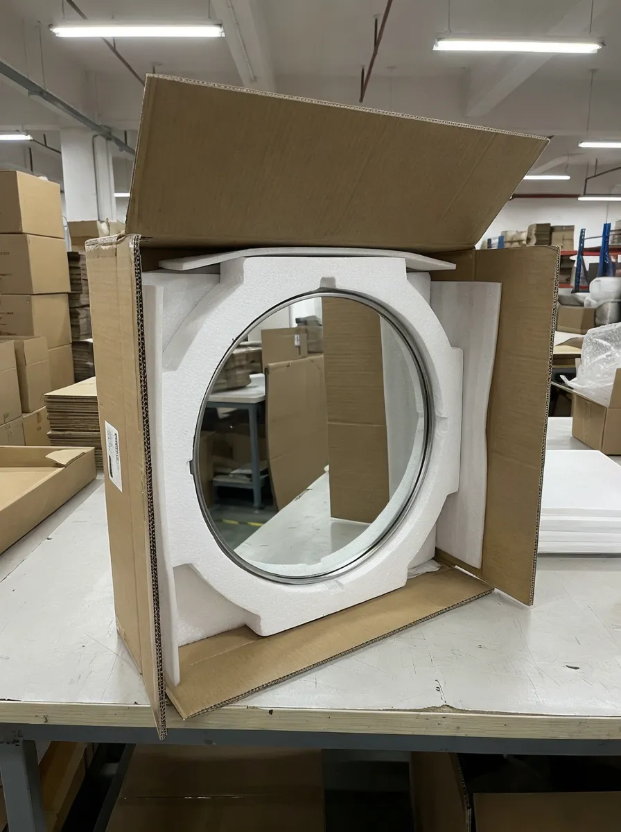 Round mirror secured in custom-cut foam cradle inside corrugated carton