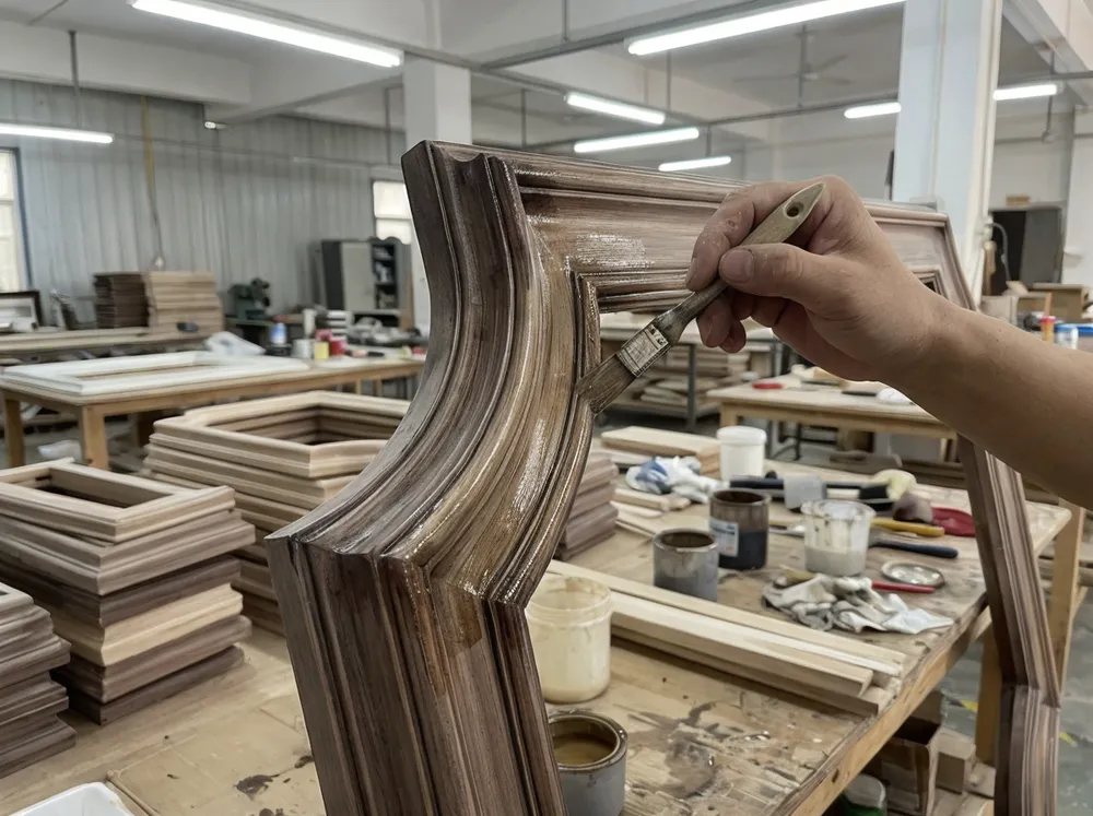 Close-up detail of luxury mirror frame construction showing multi-layer finish application