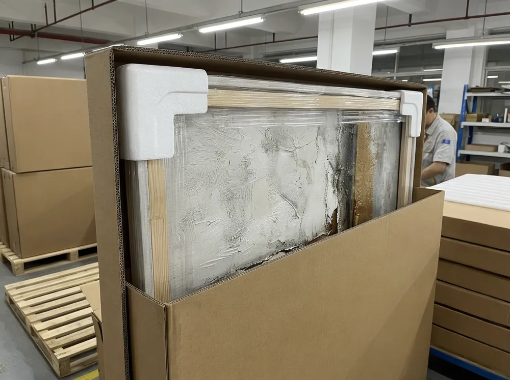 Multi-layer packaging protection for textured canvas showing PE film, foam corners, and spacer frame
