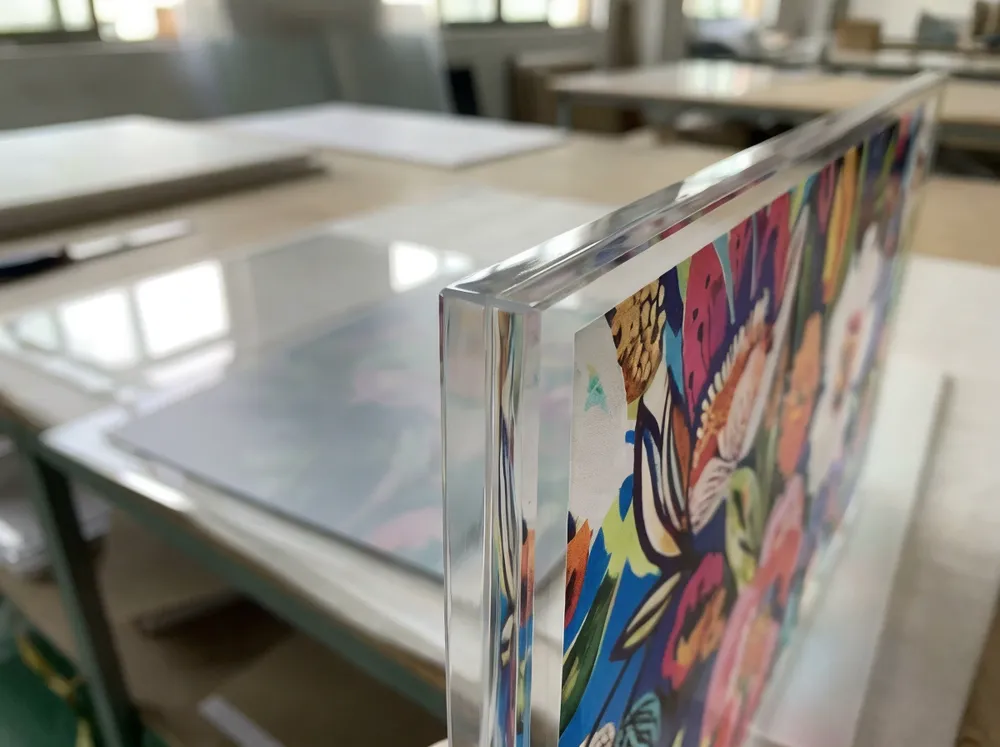 Close-up of cast acrylic panel showing diamond-polished edge finish and UV print clarity