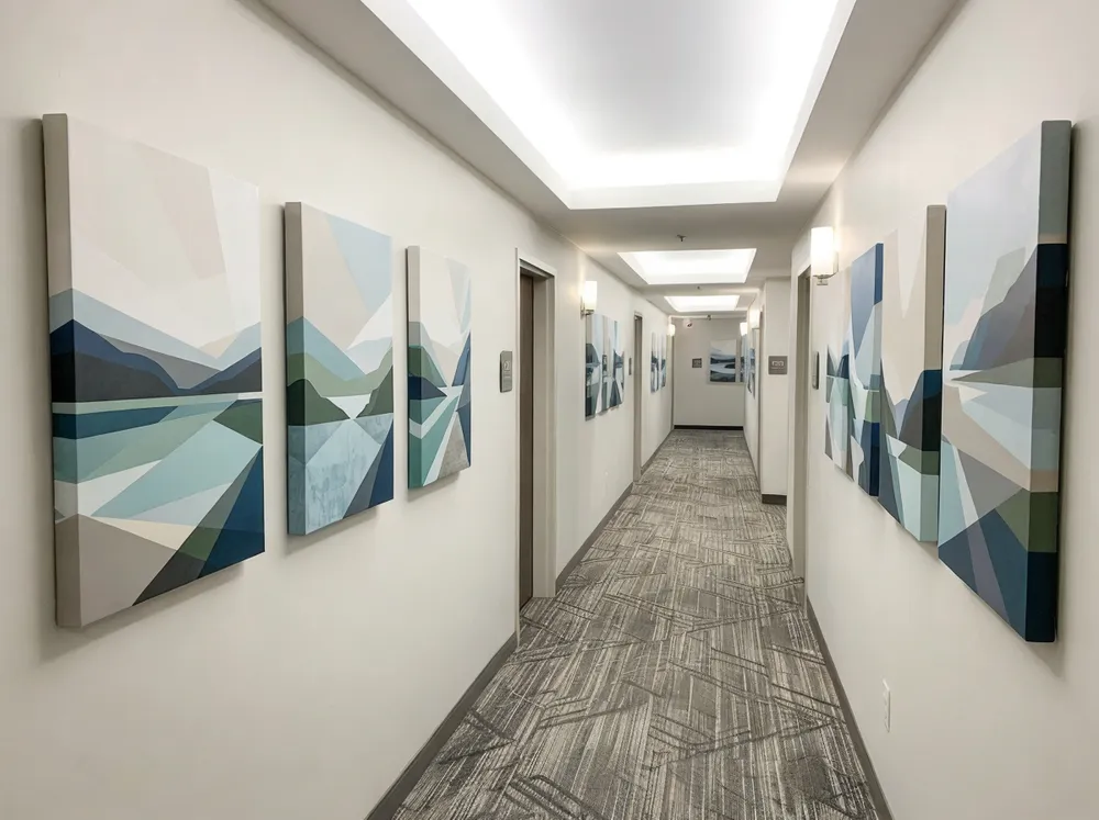 Canvas artwork installed in hotel corridor with consistent branding