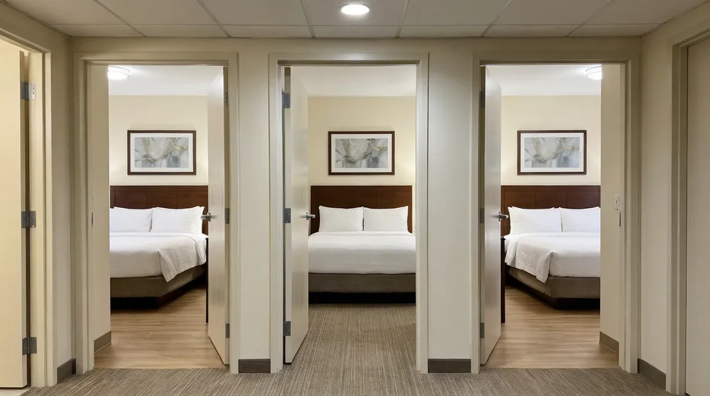 Consistent bedroom wall art installation across multiple hotel room units