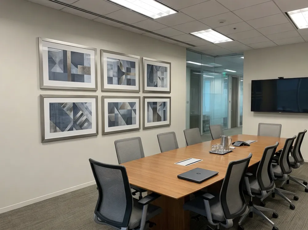 Corporate office fit-out with coordinated wall art installations in conference room