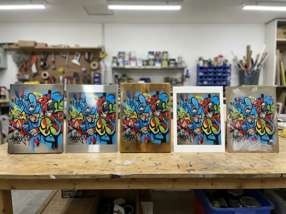 Multiple graffiti wall art samples showing different finish and substrate options side by side