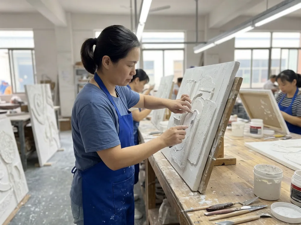 Artisan applying texture medium by hand to dimensional wall art piece