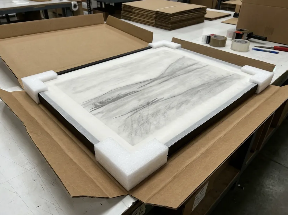 Drawing packaging with foam corner protectors and glassine sheet